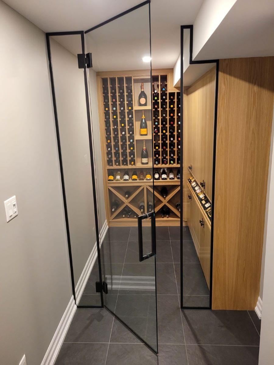 walk in glass wine cellar with matte black hardware and trim all around the glass