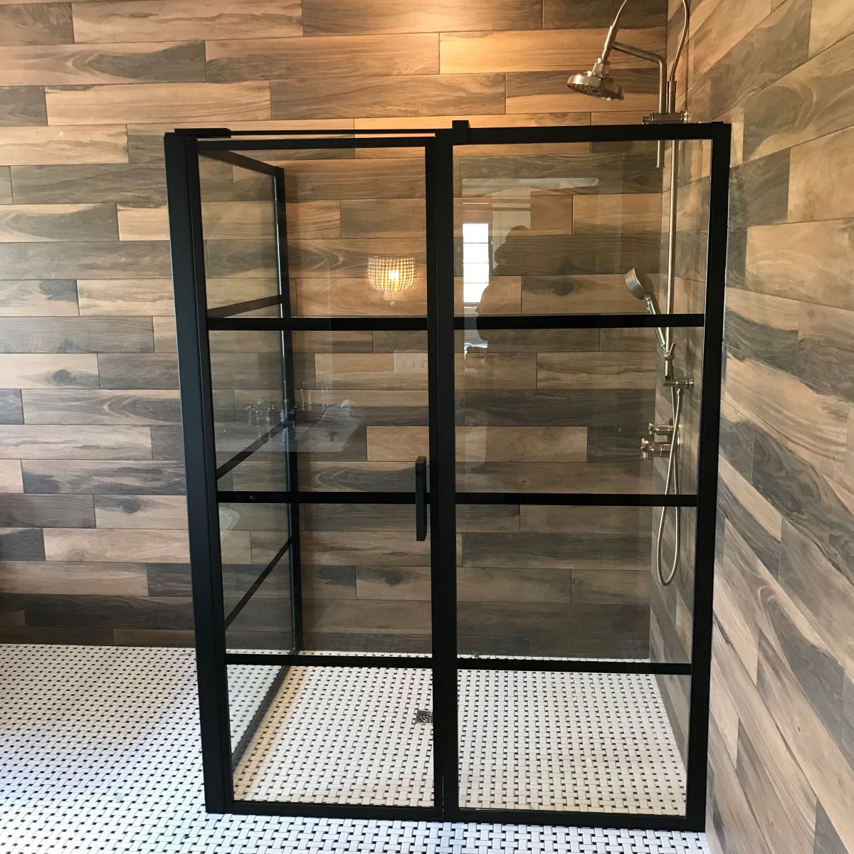 kit shower with matte black hardware and mullion strips across it