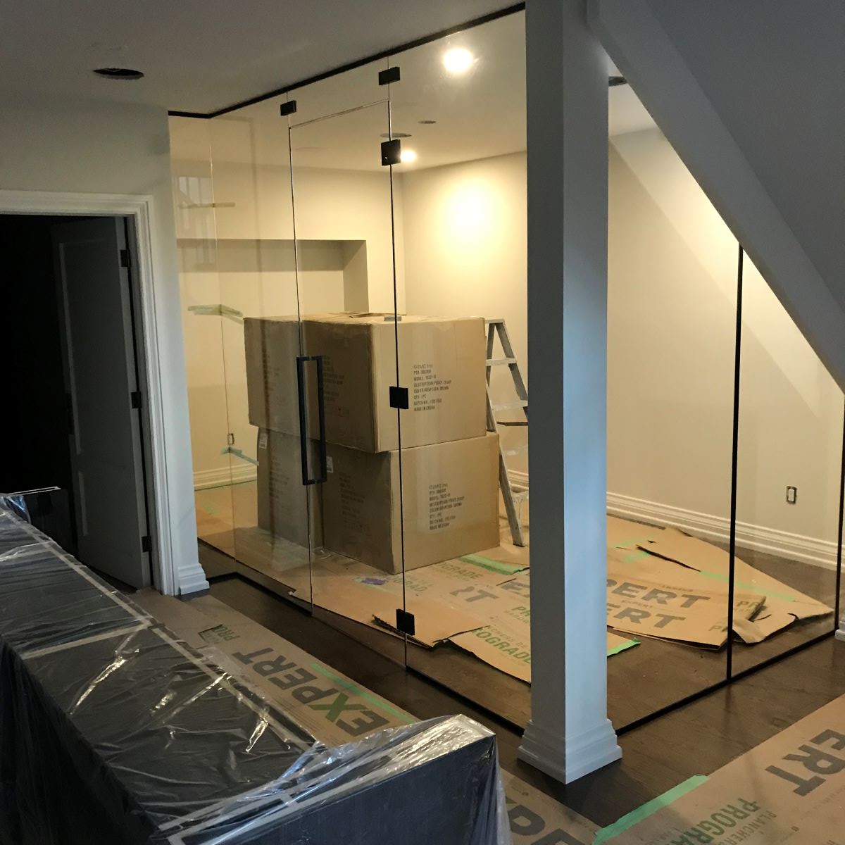 seven piece glass office with one door hinged to glass and matte black hardware, with 24" square handle 