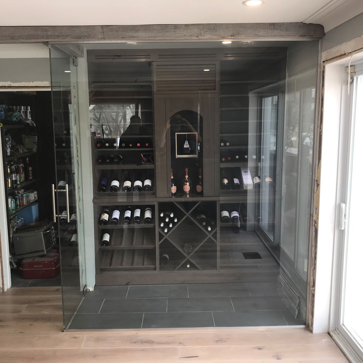 one door walk in wine cellar with brushed nickle hardware and ladder pull handle 