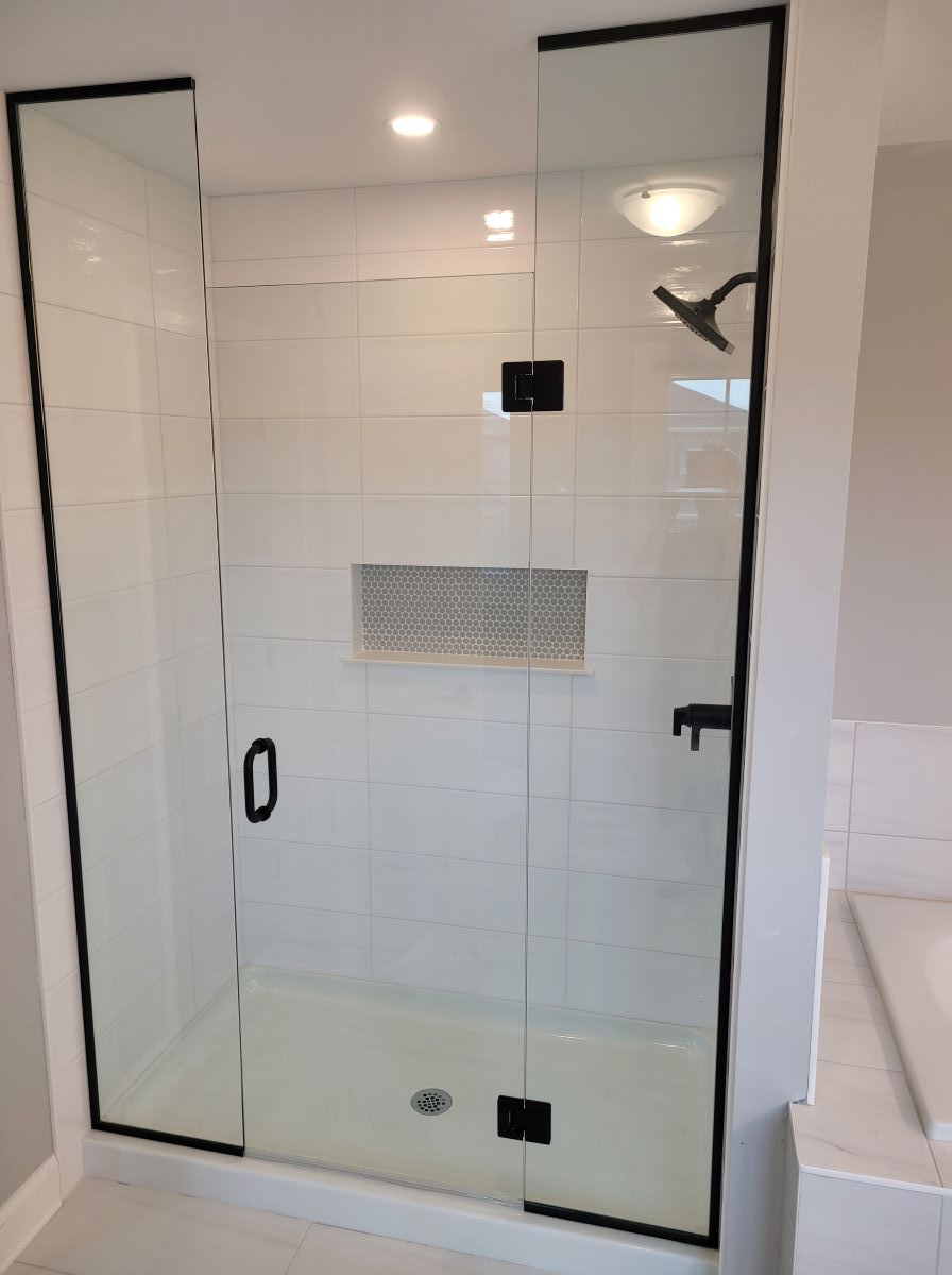 custom glass inline shower with floor to ceiling glass and matte black hardware 