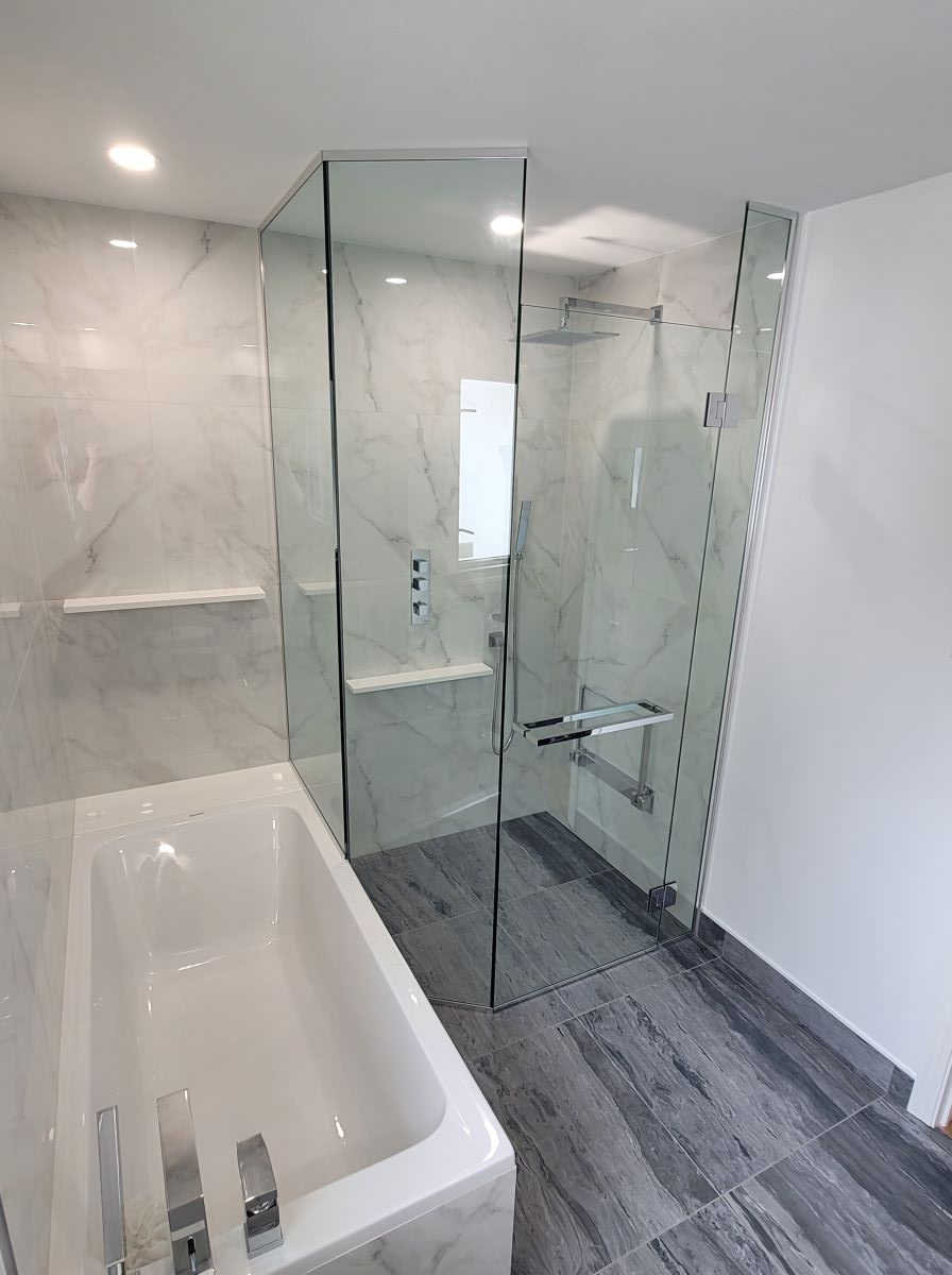 custom glass neo angle shower with floor to ceiling glass and double towel bar handle 