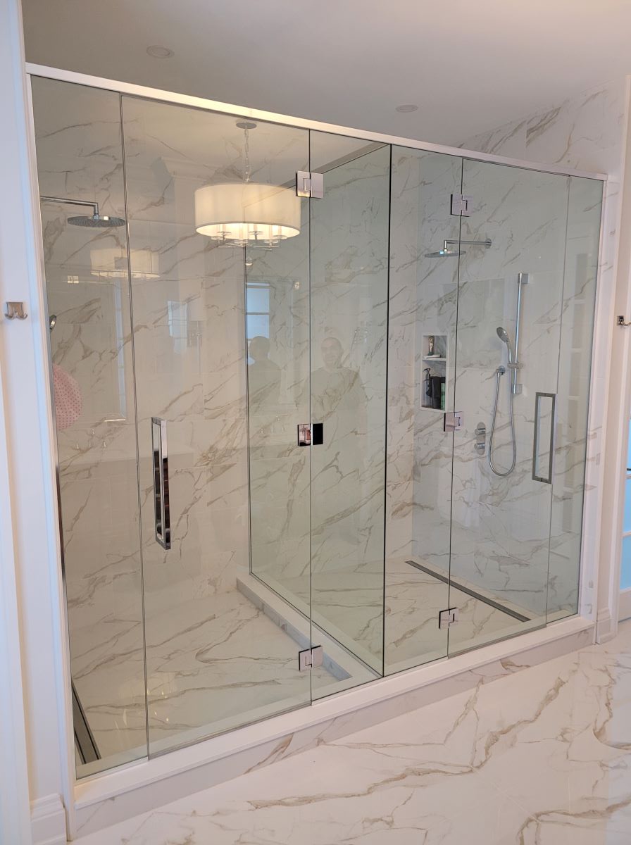 custom double glass shower with glass mounted hinges and large square handles 