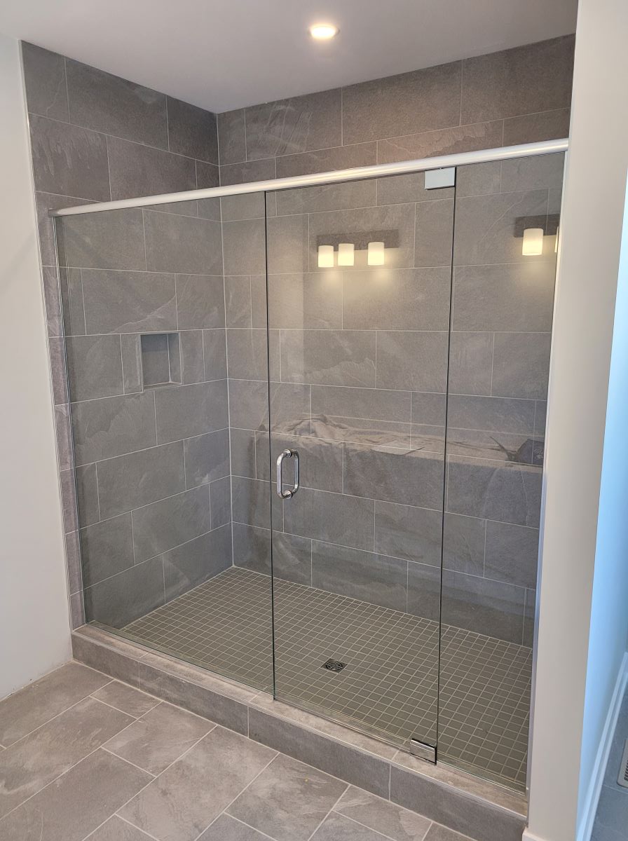 custom inline glass shower with pivot door and header all chrome hardware