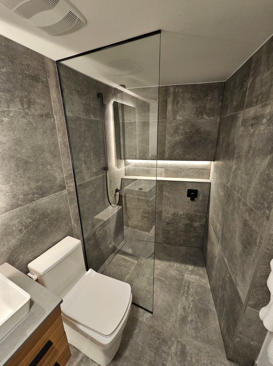 glass shower screen installed with low profile matte black channels and no door 