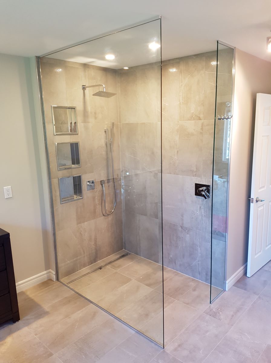 open concept glass shower with the glass all the way to the ceiling and chrome hardware 