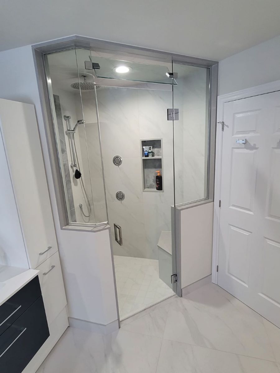 custom glass steam shower with a movable transom above the door and 2 knee walls with all chrome hardware 