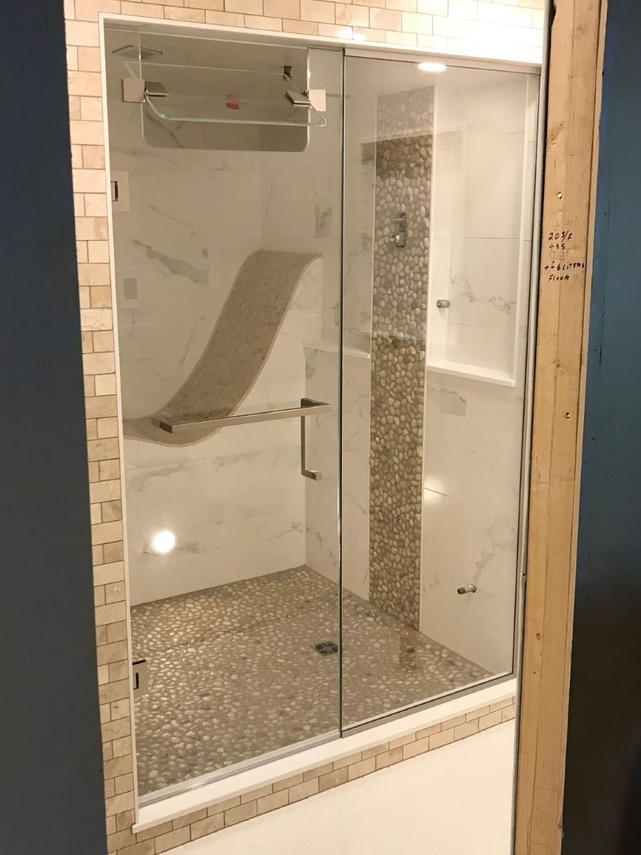 custom glass steam shower with the transom built in the door and a square towel bar handle combo 