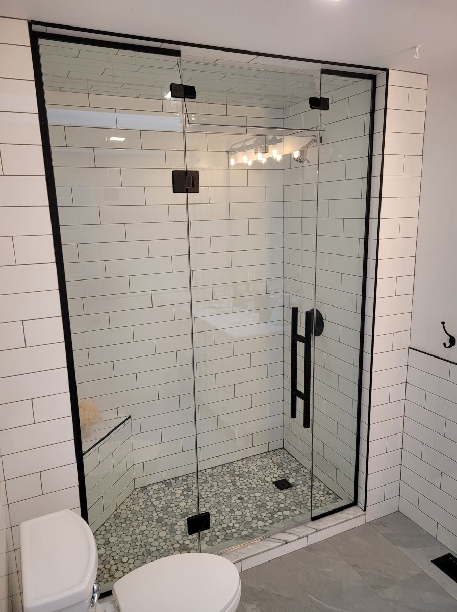custom glass steam shower with a movable transom and matte black hardware with a 24" ladder pull handle 